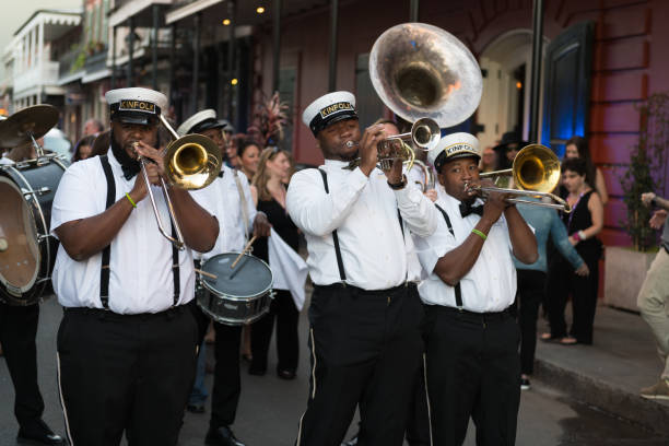 New Orleans, USA - Nov 3, 2018: A Second Line moving down Bourbon street in the french quarter late in the day.